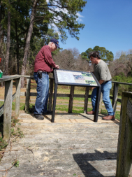 Volunteers install new interpetive signs